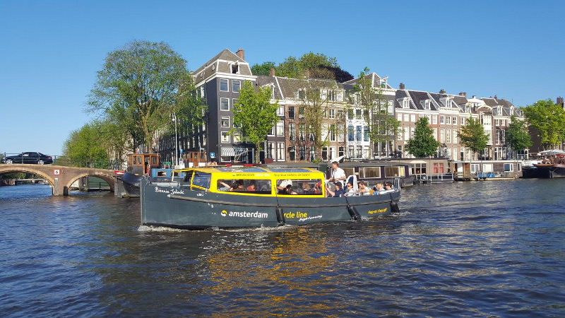 An Amsterdam Circle Line cruises the canals of Amsterdam