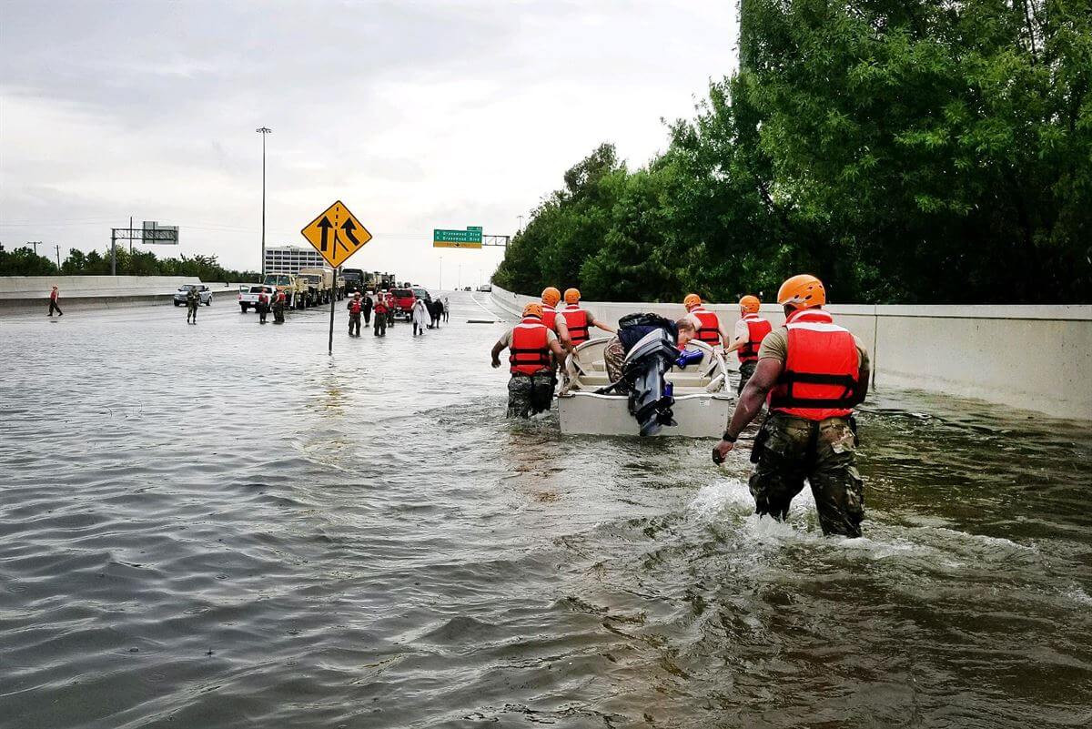 Rescue workers traverse floodwaters