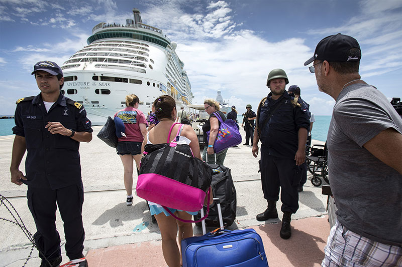 People walking toward Adventure of the Seas while the ship was anchored in St Maarten after the passage of Hurricane Irma