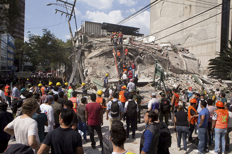 Volunteers and first responders look for survivors in a collapsed building after an earthquake struck Mexico City