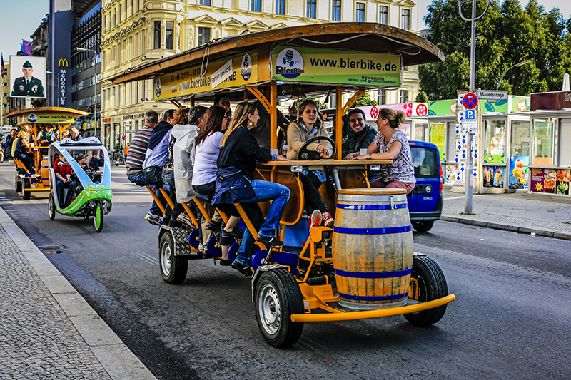 people riding a beer bike