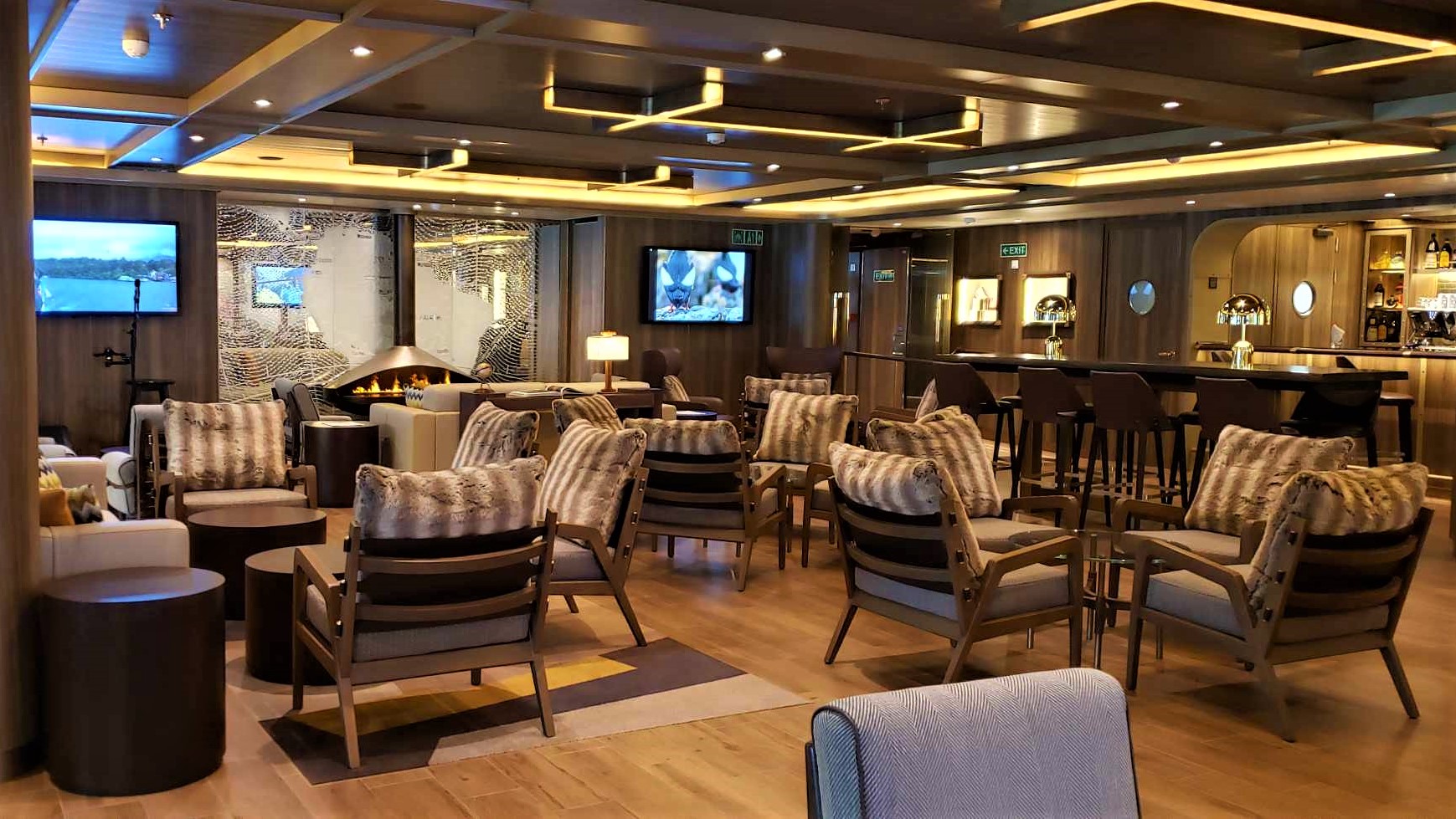 The comfortable Expedition Lounge is a favorite gathering spot on Seabourns Seabourn Venture It boasts two faux fireplaces
