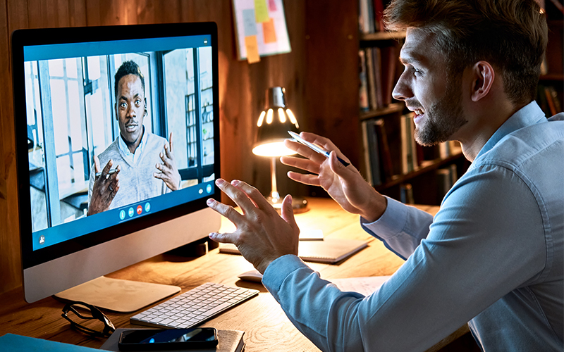 Two men connect over a virtual meeting