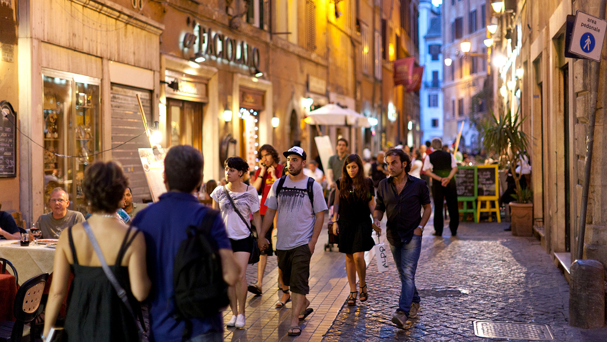 People walking down a street in Rome