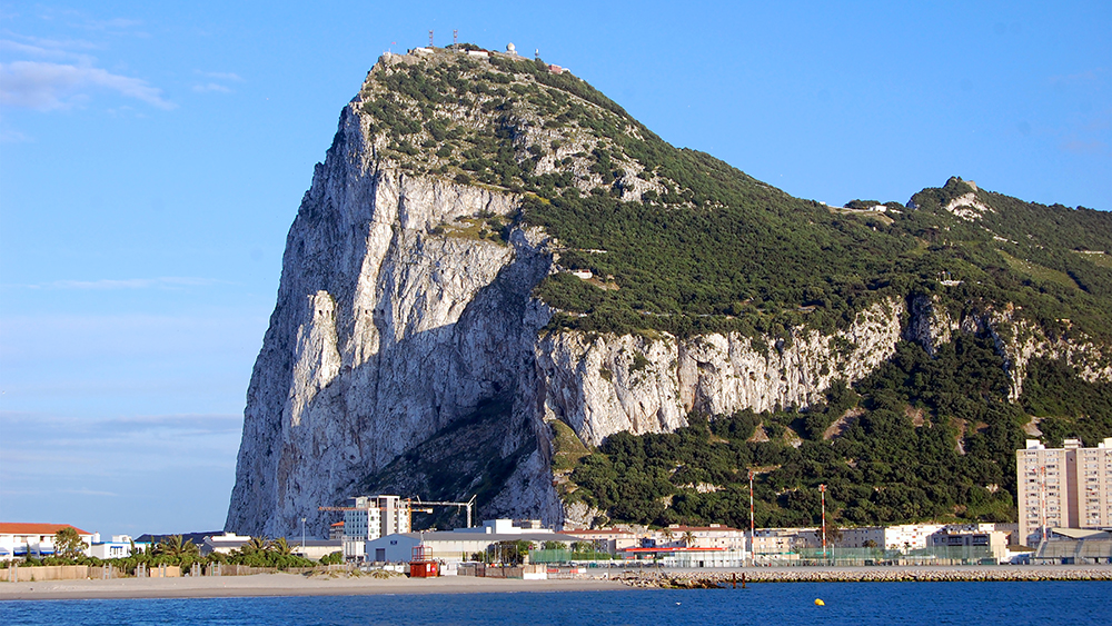 The craggy famous Rock of Gibraltar with the beach and town below