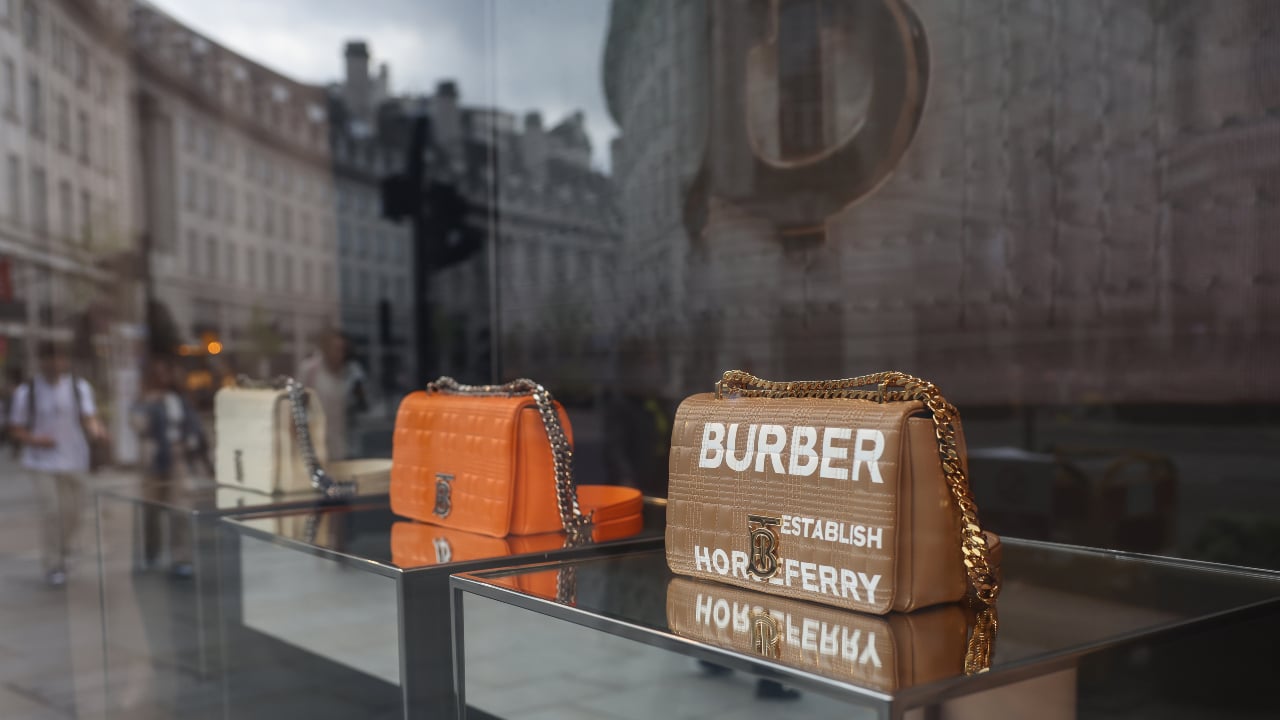 Luxury handbags displayed in a Burberry shop window on Regent Street