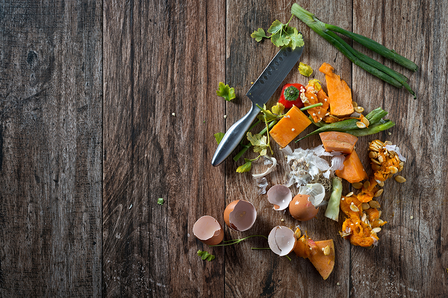 food scraps on a table with a knife