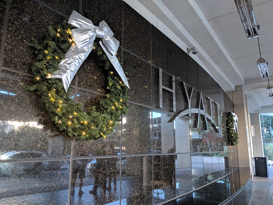 Two wreaths frame the Hyatt logo at the Hyatt Regency Dallas