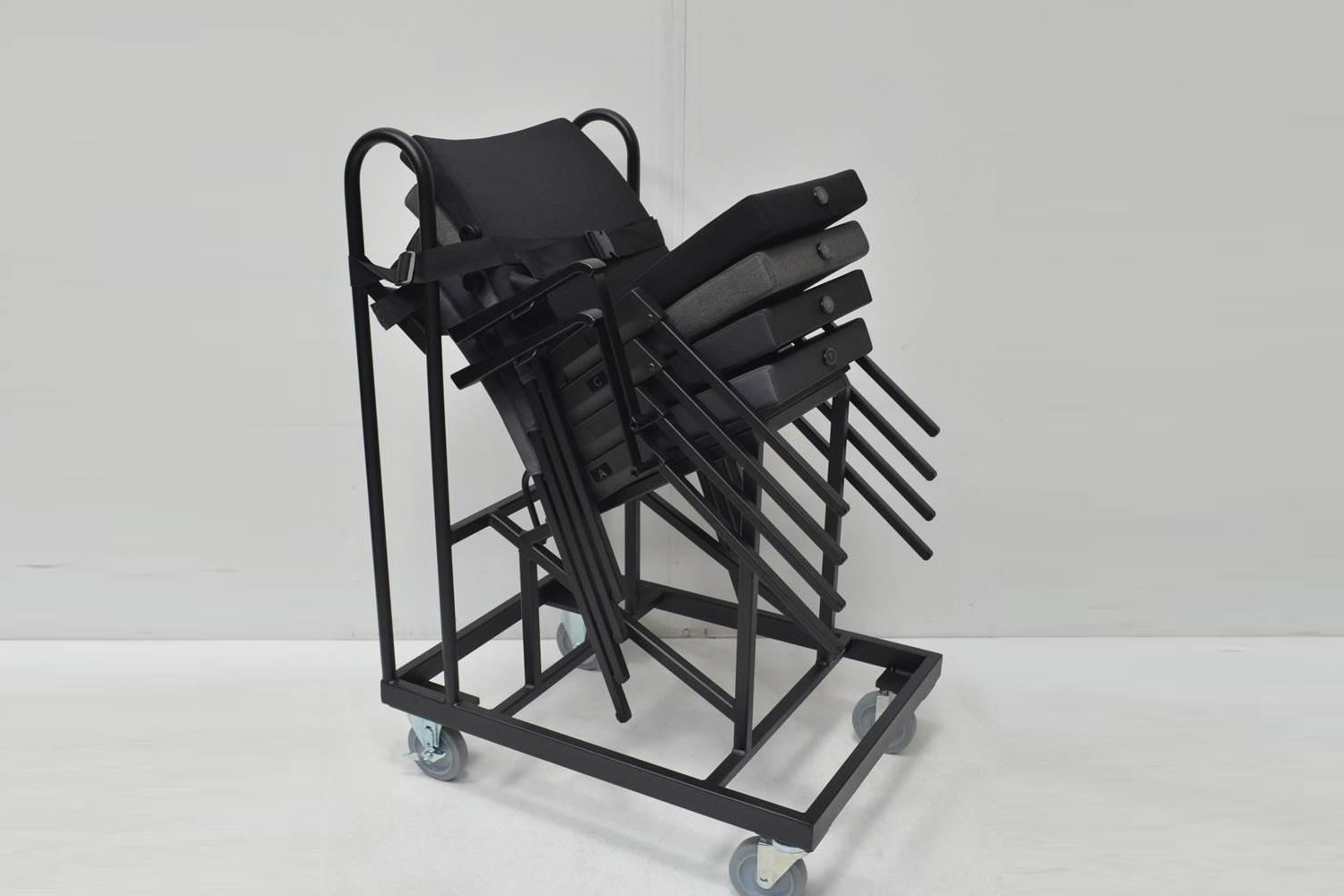 The SERIES Model-K chair is an upholstered theater stacking chair featuring an automatic gravity-return self-lifting seat