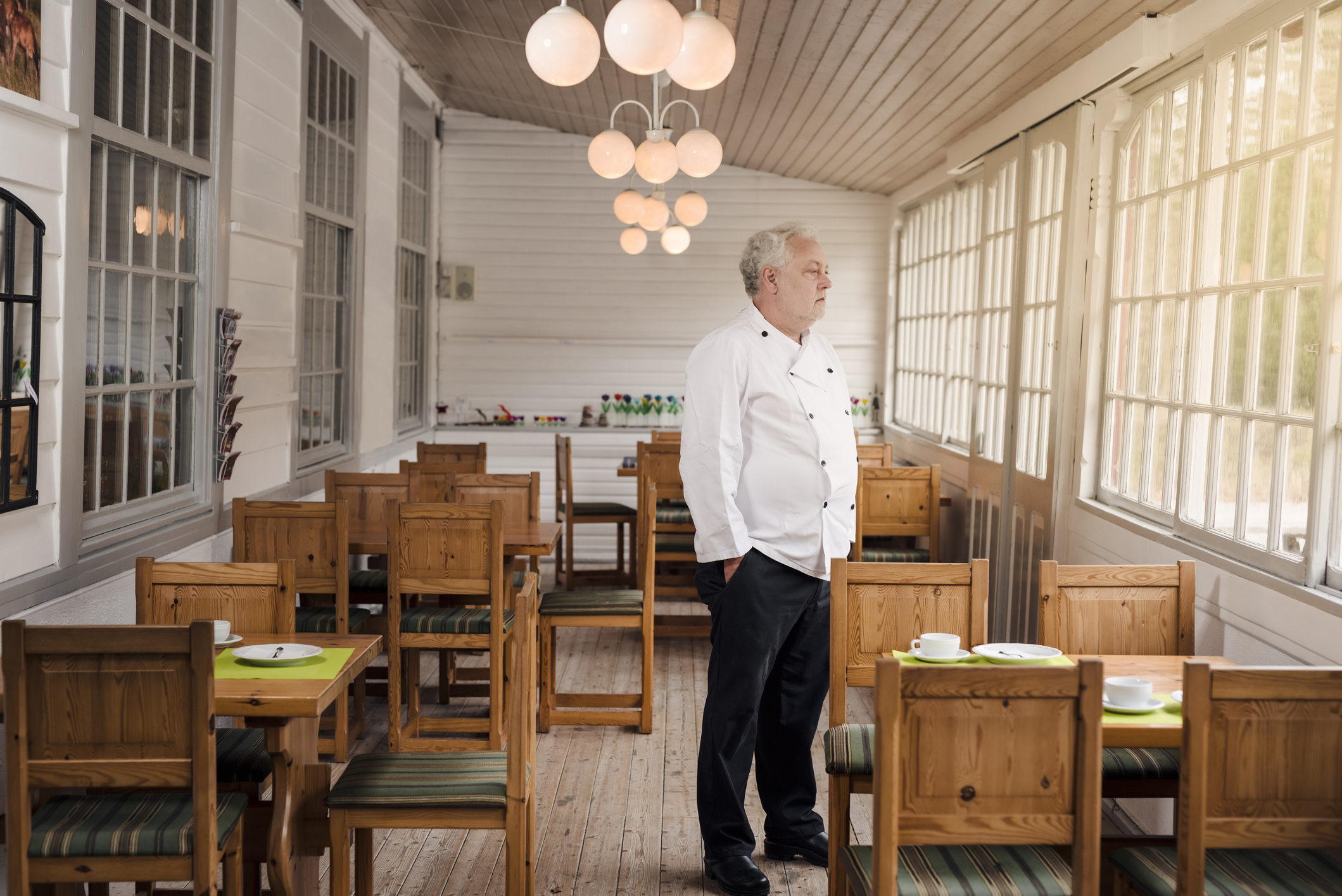 A restaurant owner stands in his empty restaurant 