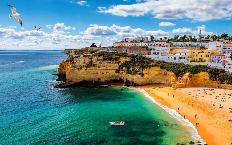 View of Carvoeiro fishing village with beautiful beach Algarve Portugal View of beach in Carvoeiro town with colorful hous