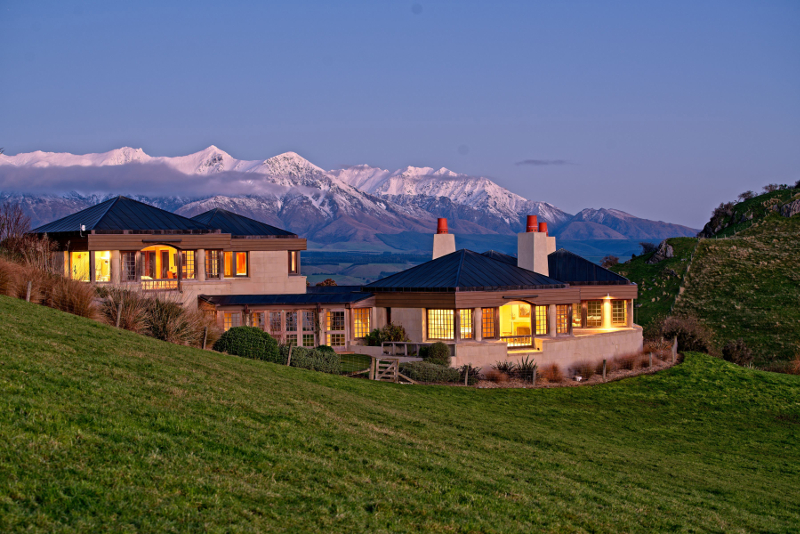 Cabot Lodge sits among the green hills with mountains in the background