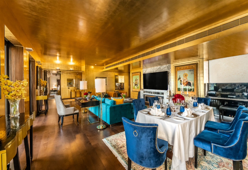 The Sultan Suites living and dining area with walls covered in gold leaf