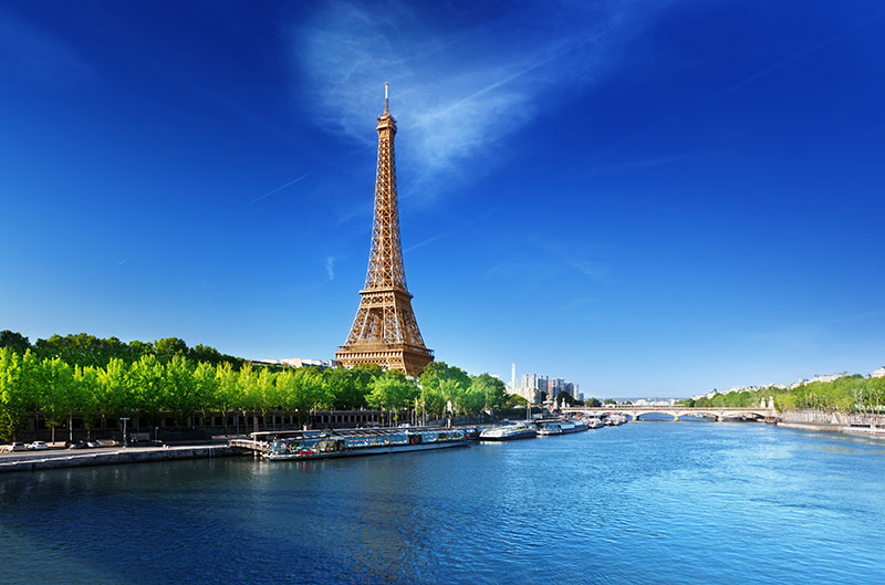 The Seine River flowing by the Eiffel Tower in Paris