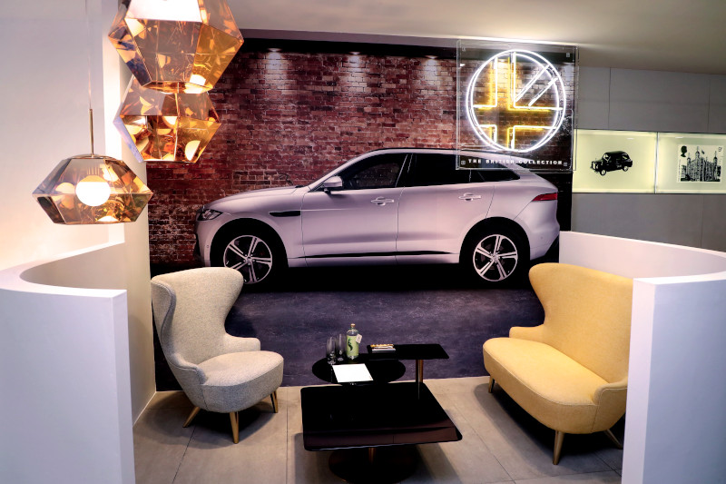 A lounge with an image of a car plastered on the wall 