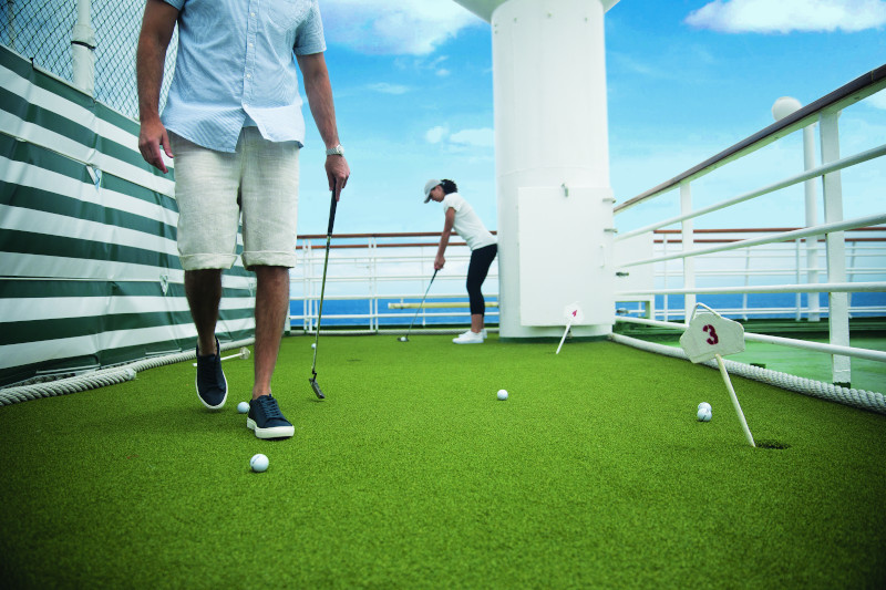 Image of individuals on a cruise putting green 