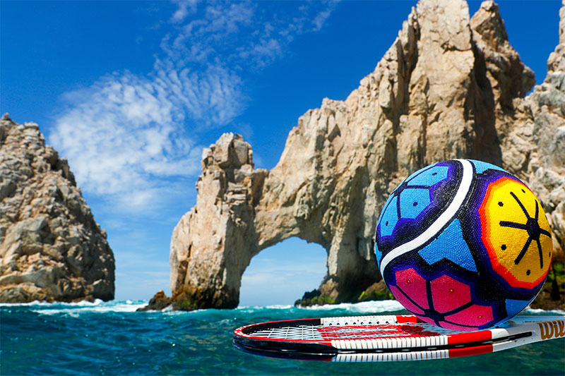 Tennis racket and ball in front of El Arco in Los Cabos