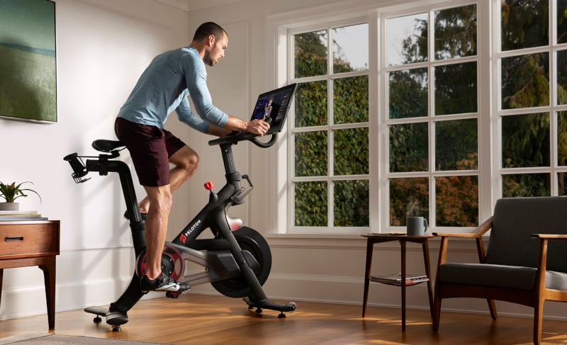Man looking out a window on exercise bike  