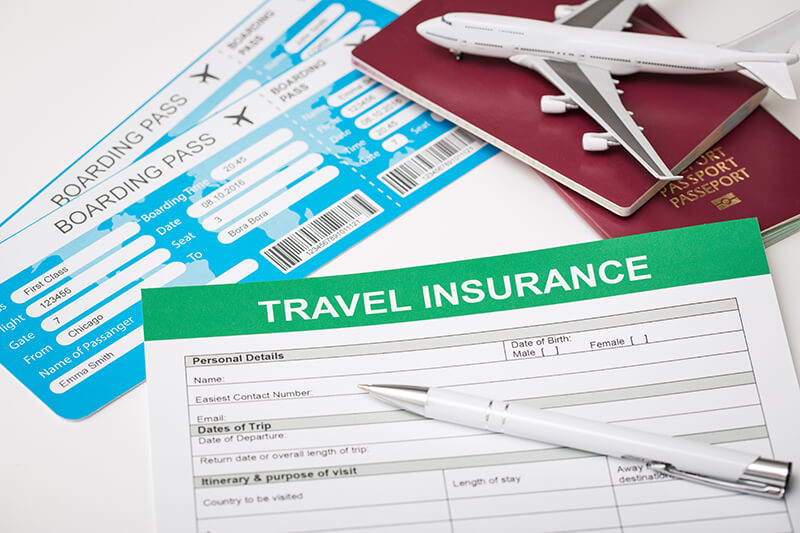 travel insurance with a model airplane tickets and a passport