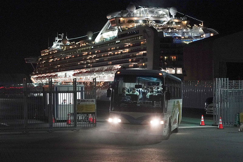 Buses carrying Australian passengers from the quarantined Diamond Princess cruise ship leave a port in Yokohama near Tokyo