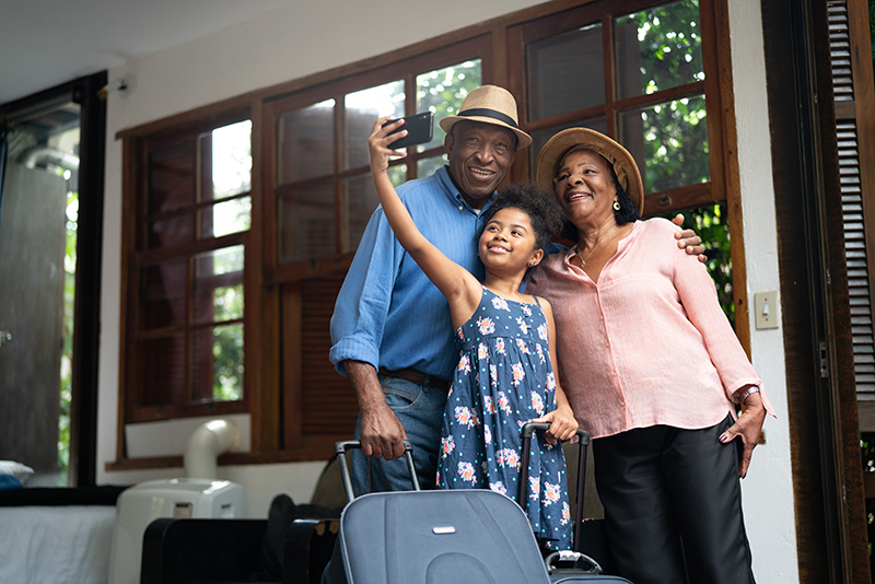 Grandparents and Granddaughter taking selfie in a hotel
