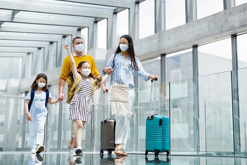 Family wearing masks at the airport