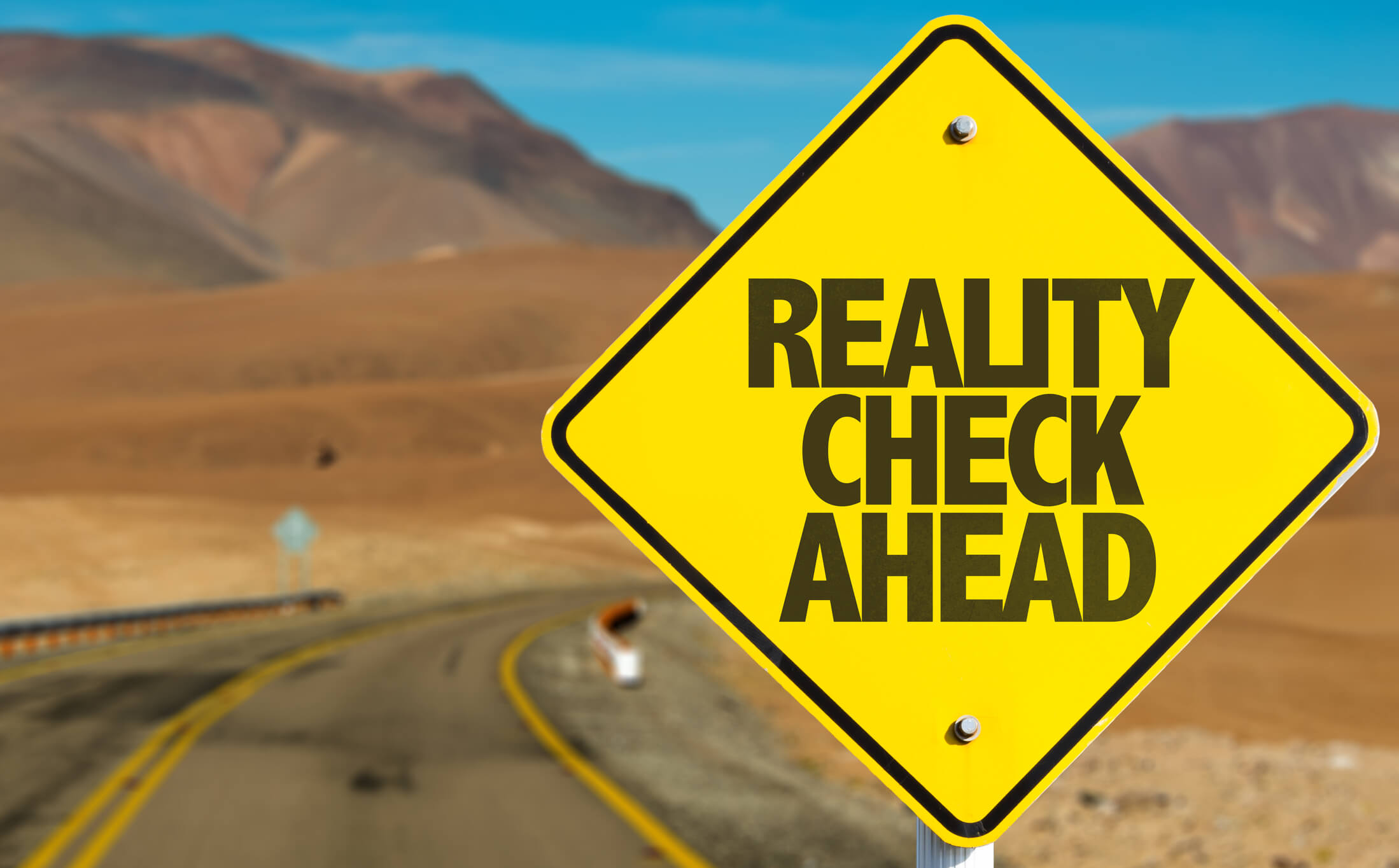 Reality check ahead road sign