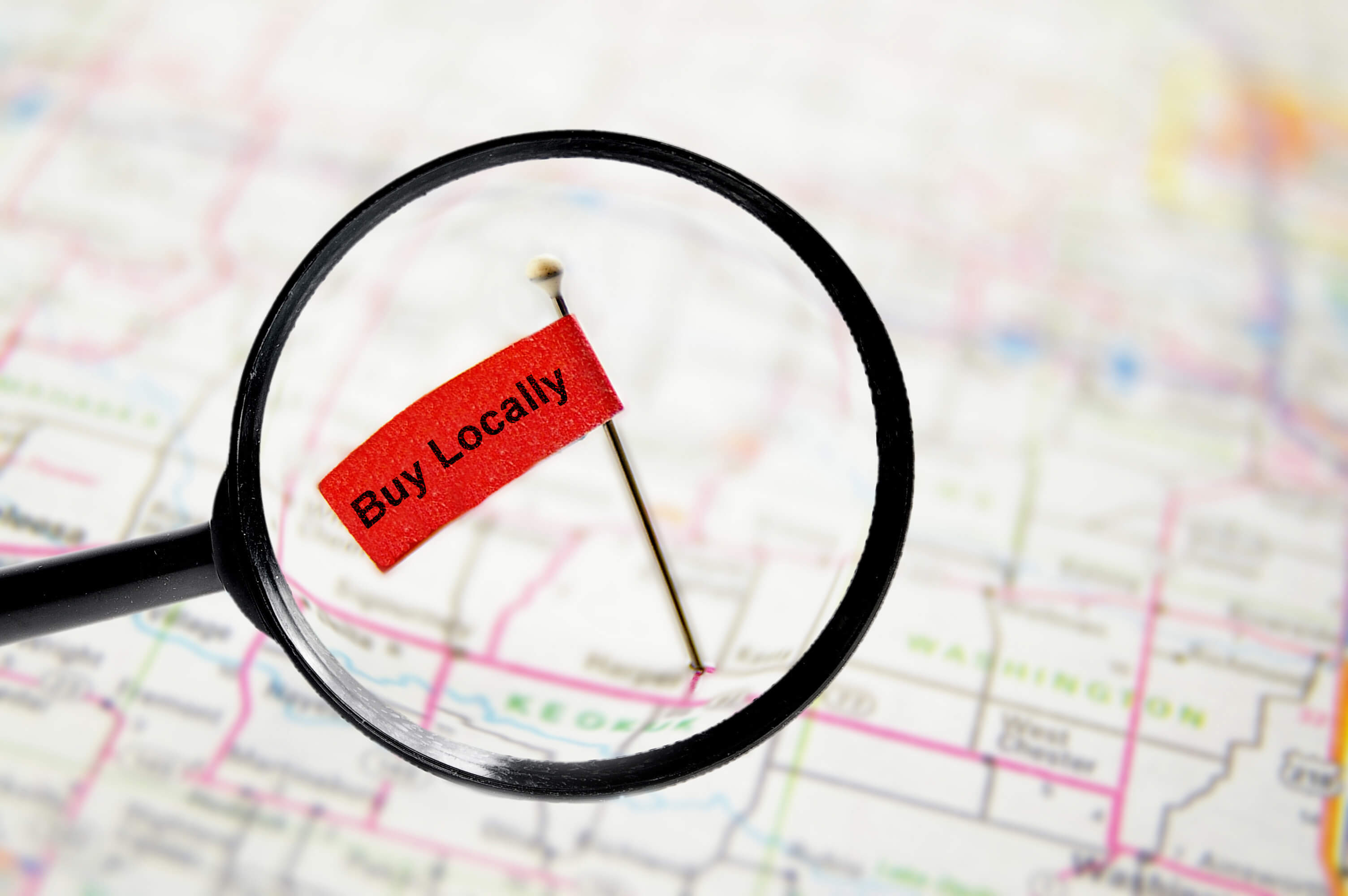 Buy Locally pin on map under magnifying glass