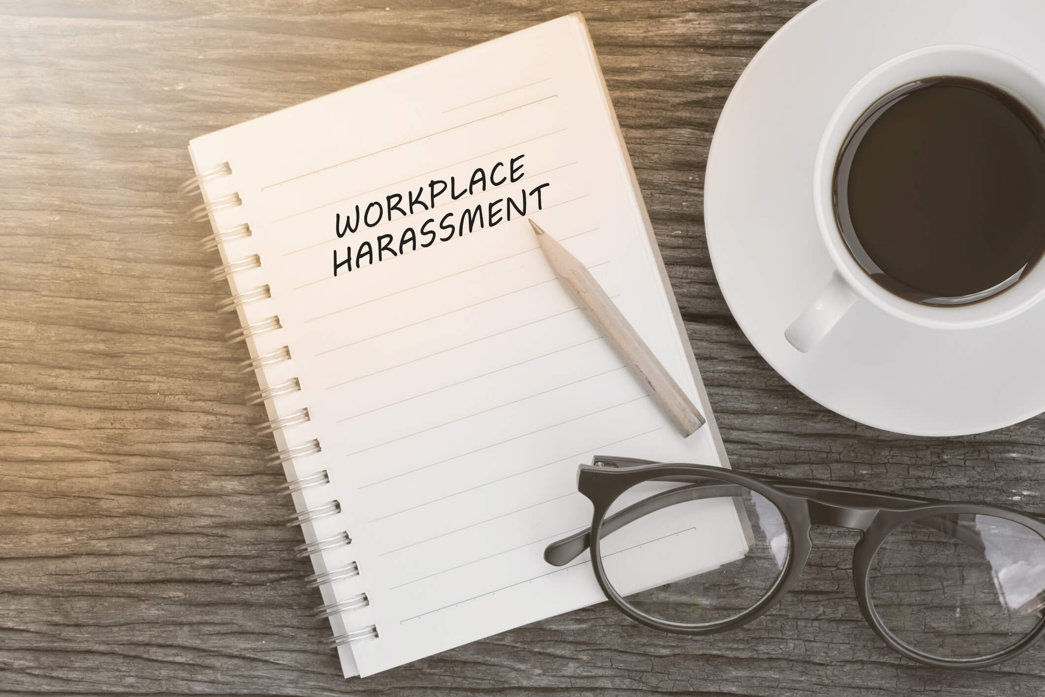 Workplace harassment notepad glasses coffee