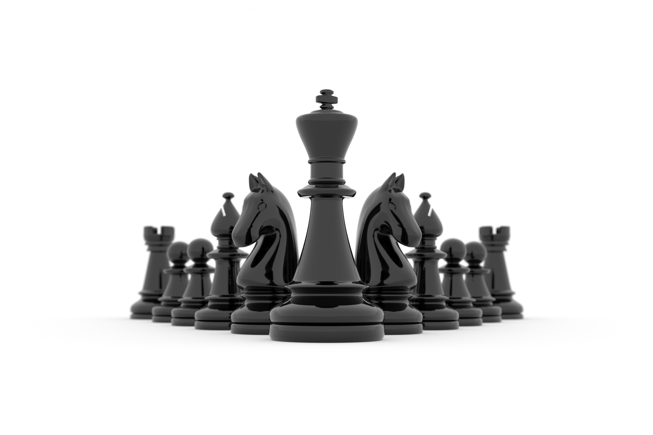 Glossy black chess pieces against a white background