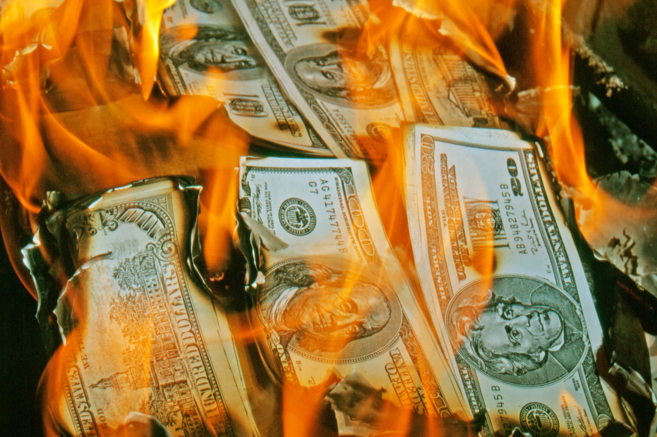 Stacks of money burning on a fire