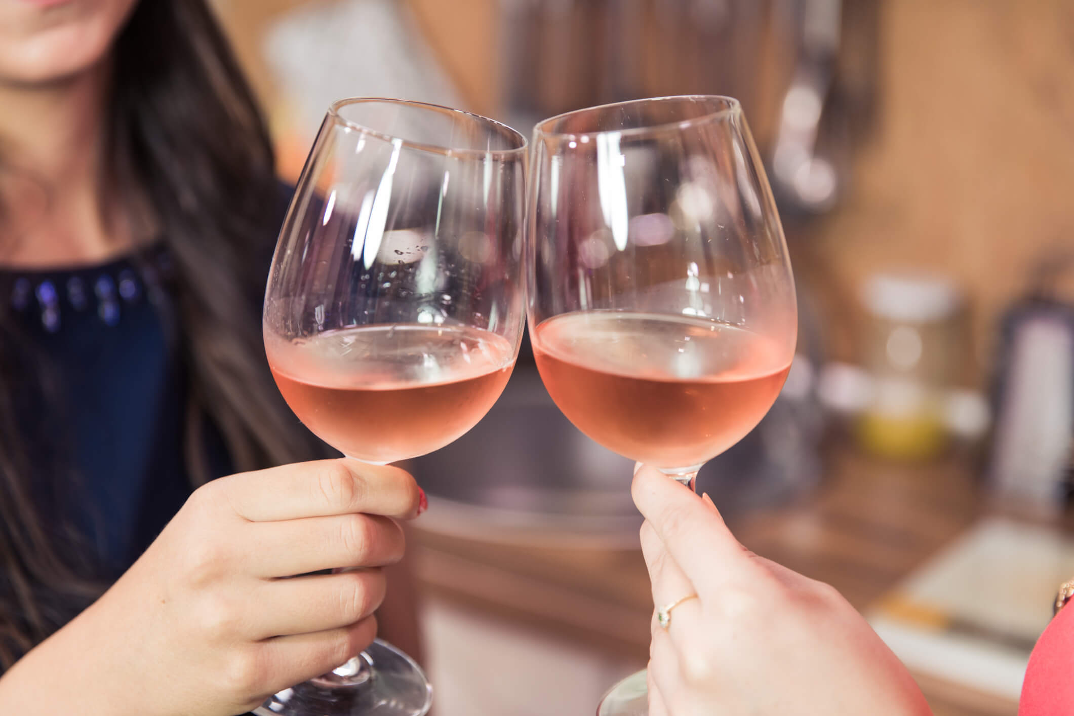 Women toasting with chilled pink wine glasses