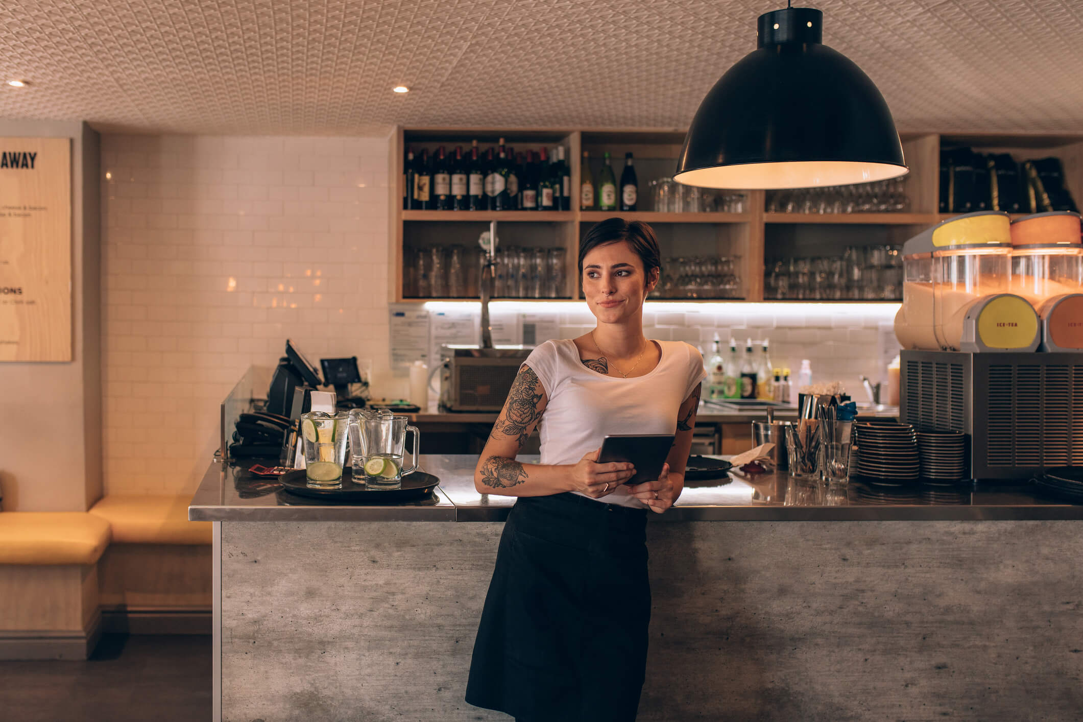 Woman bar manager holding tablet