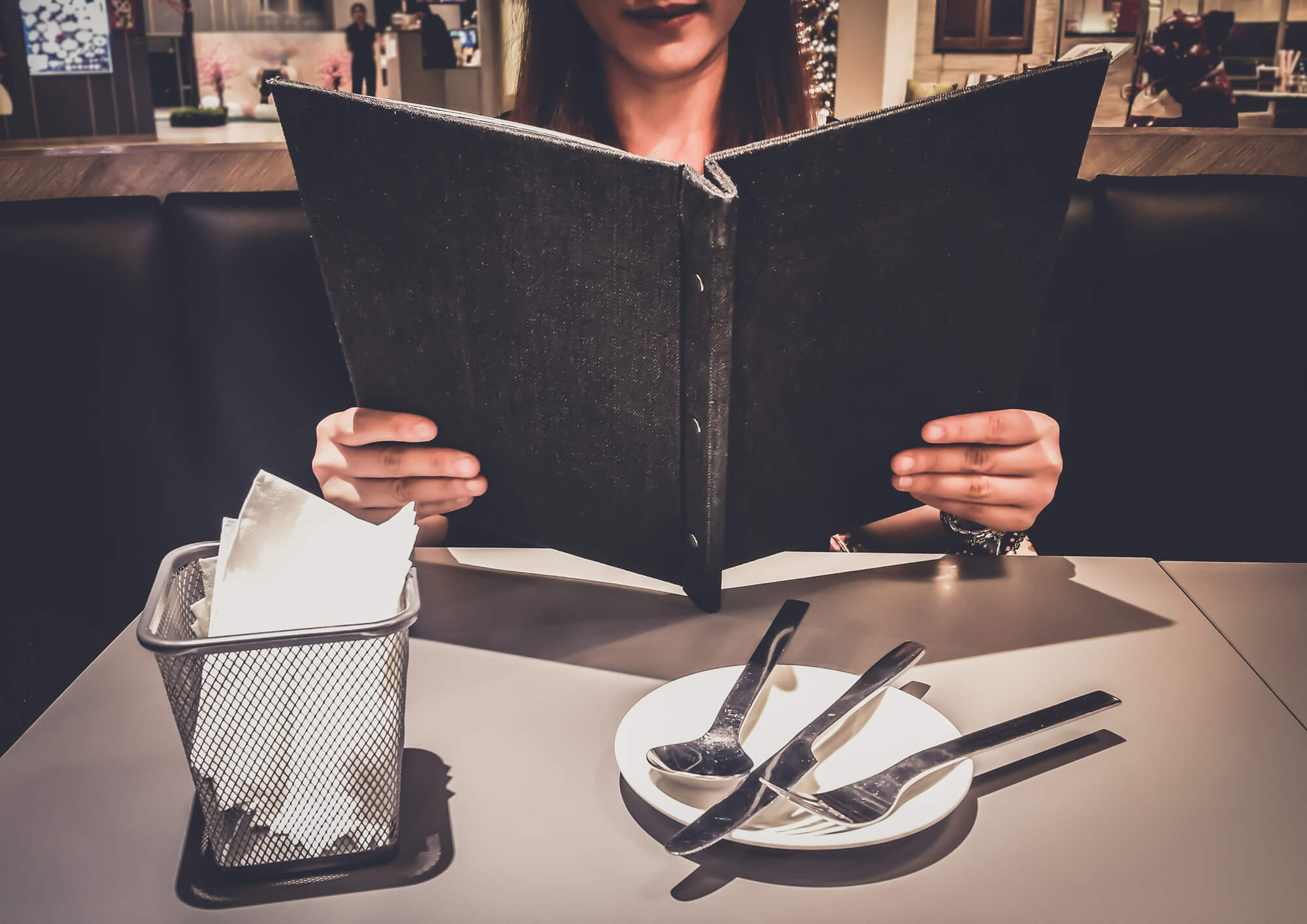 Woman reading restaurant menu