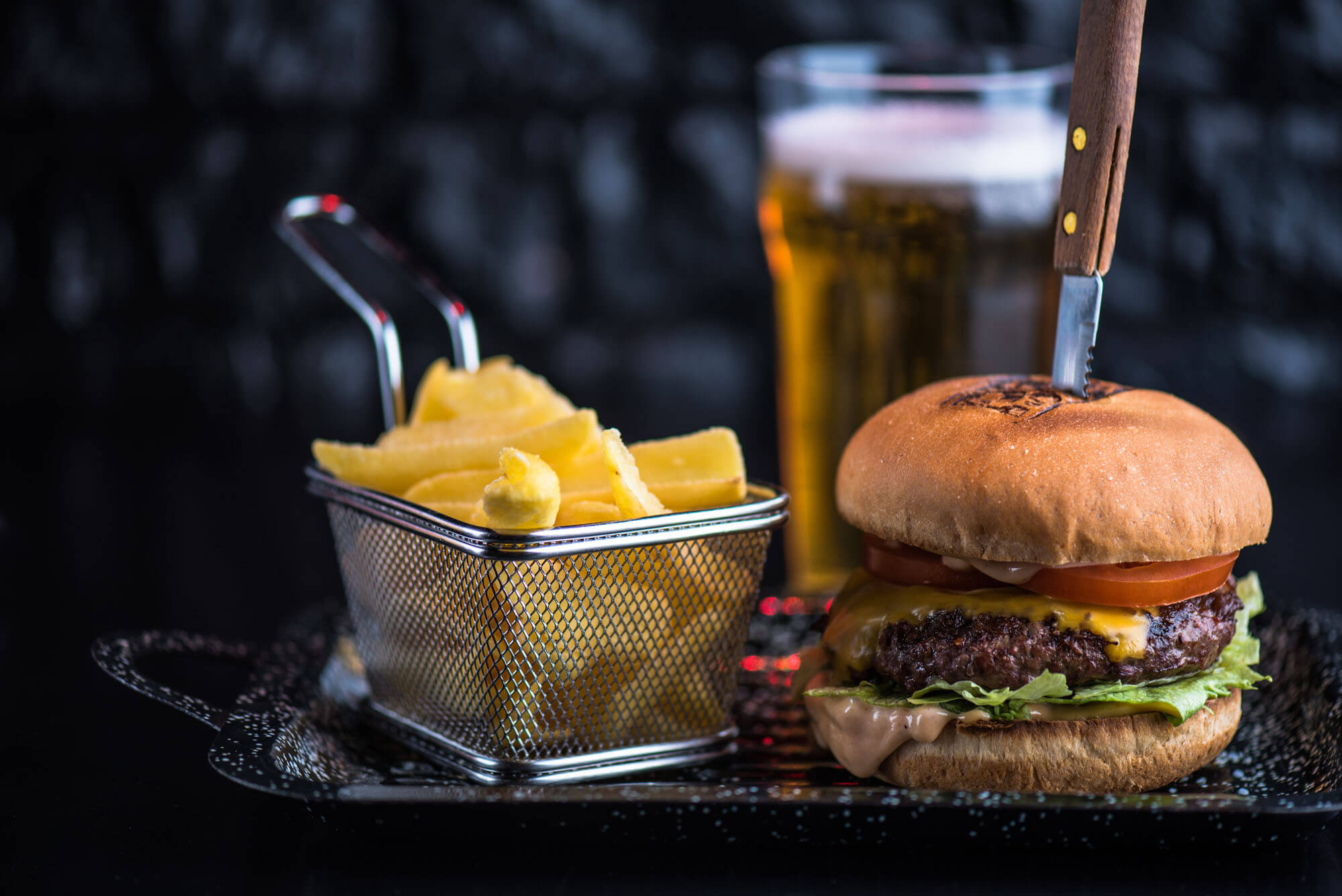 Burger with knife French fries and beer