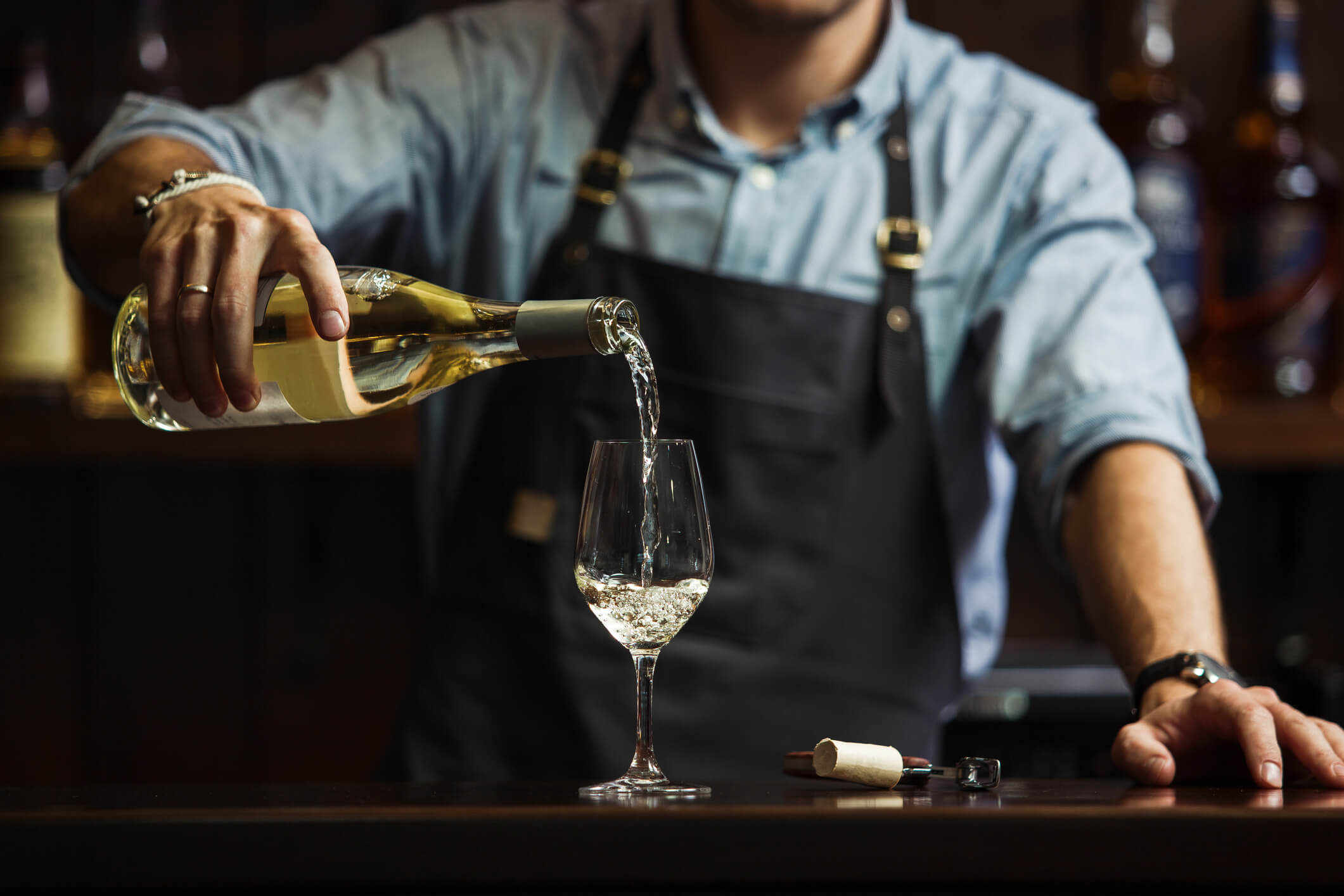 Bartender pouring wine