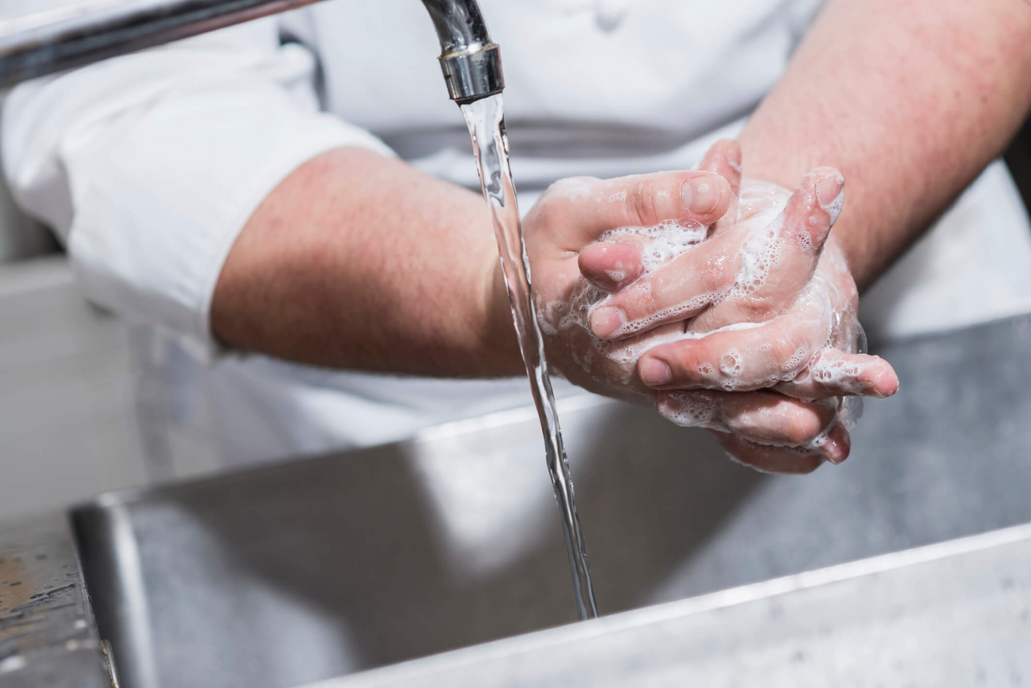 Restaurant kitchen employer washing hands