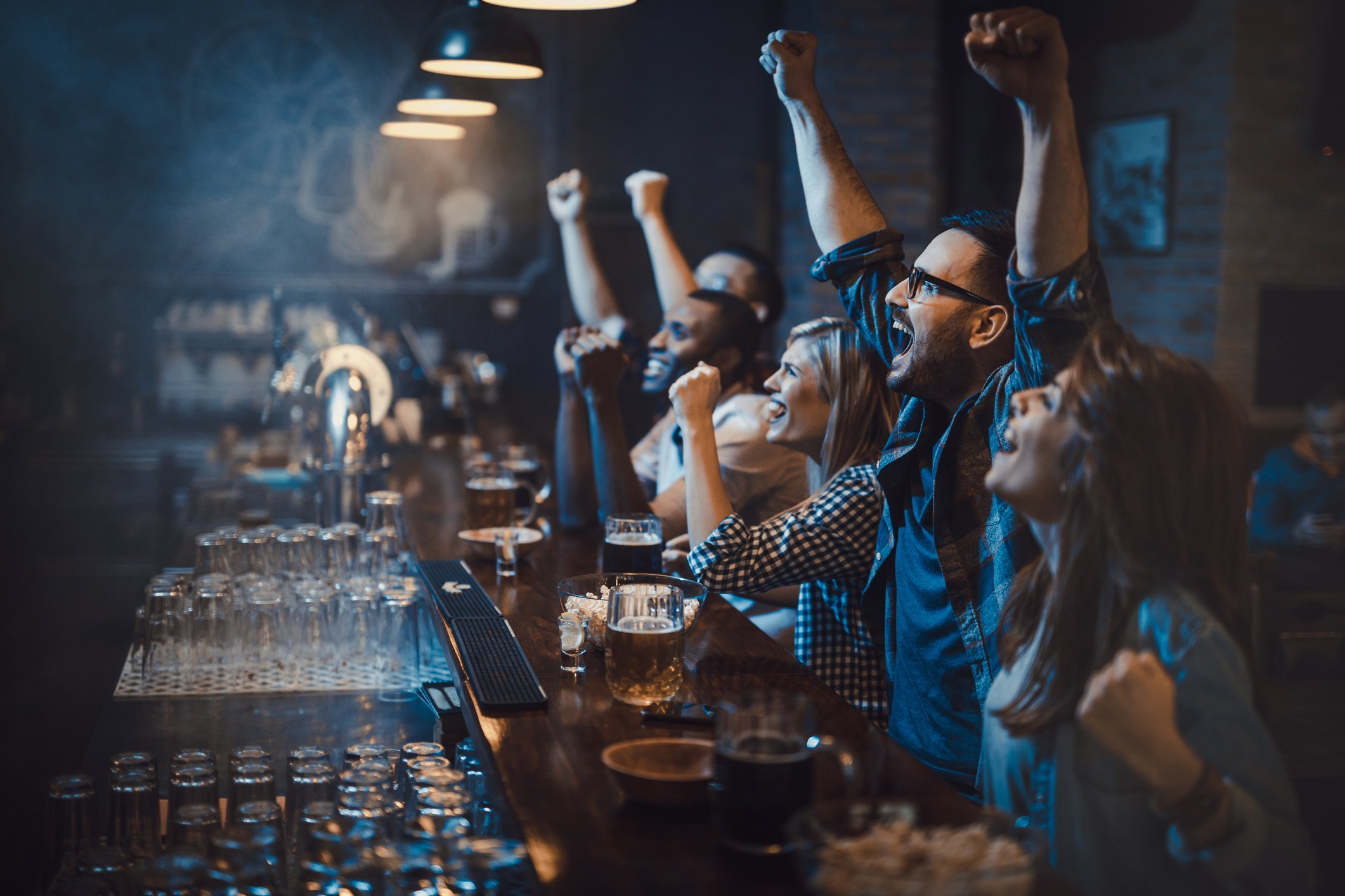 Friends celebrate at a sports bar