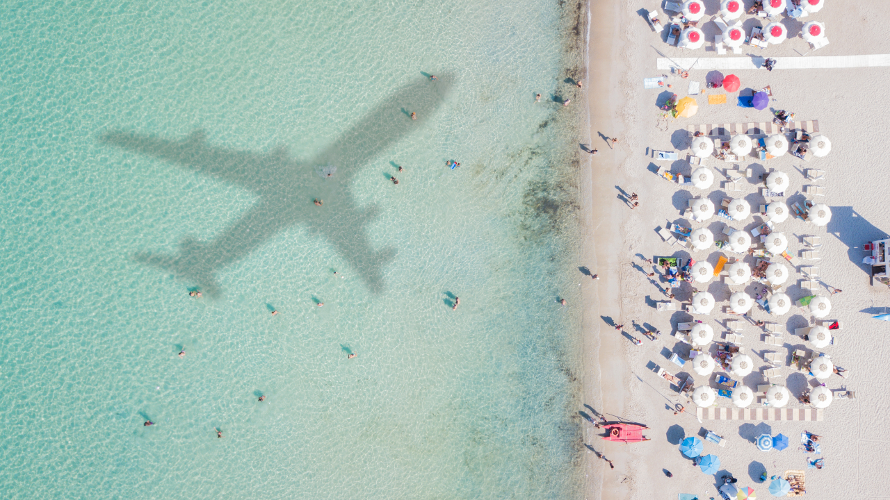 Airplane flying over beach