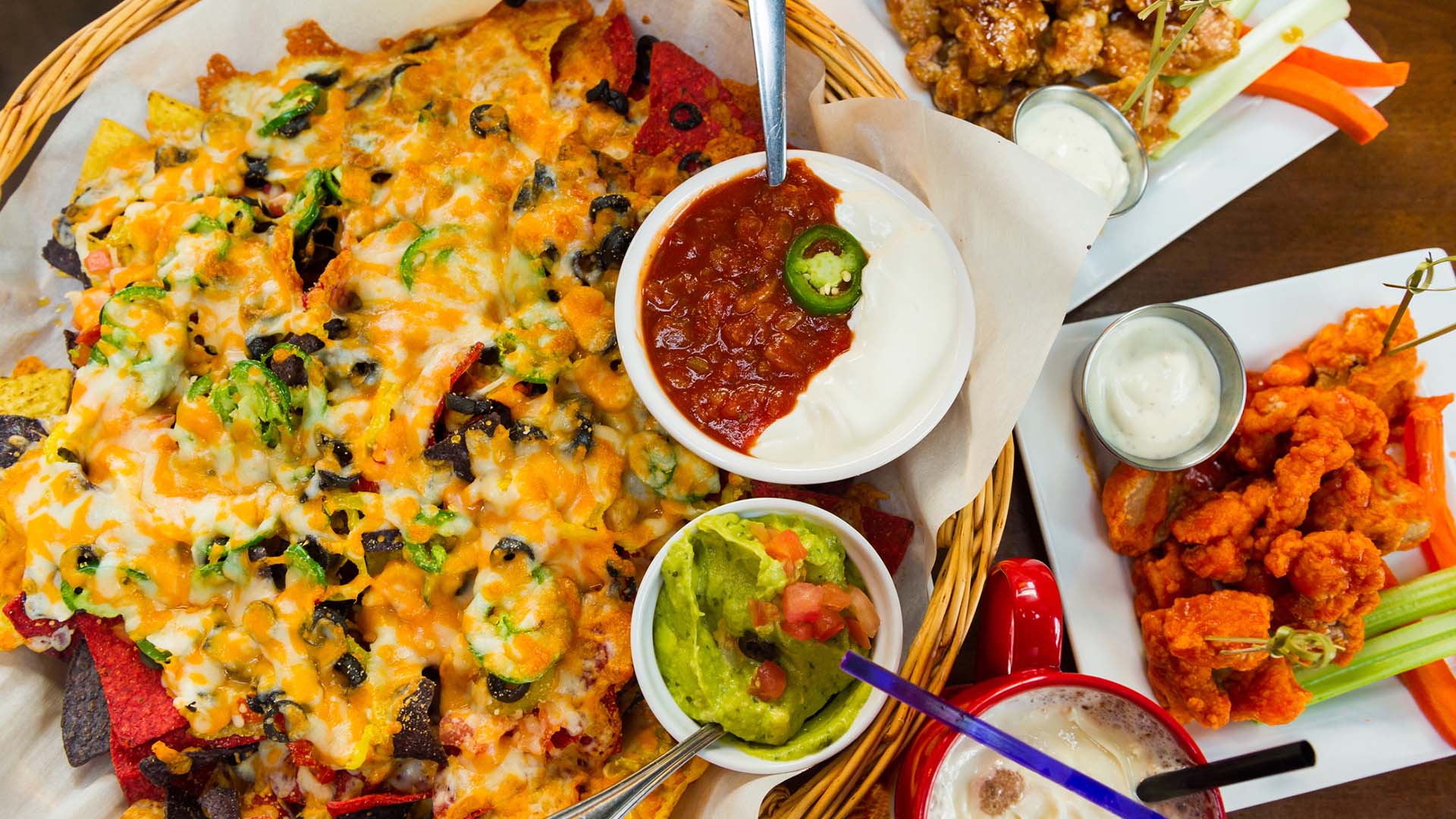 A spread of Super Bowl Sunday favorites like nachos and chicken wings