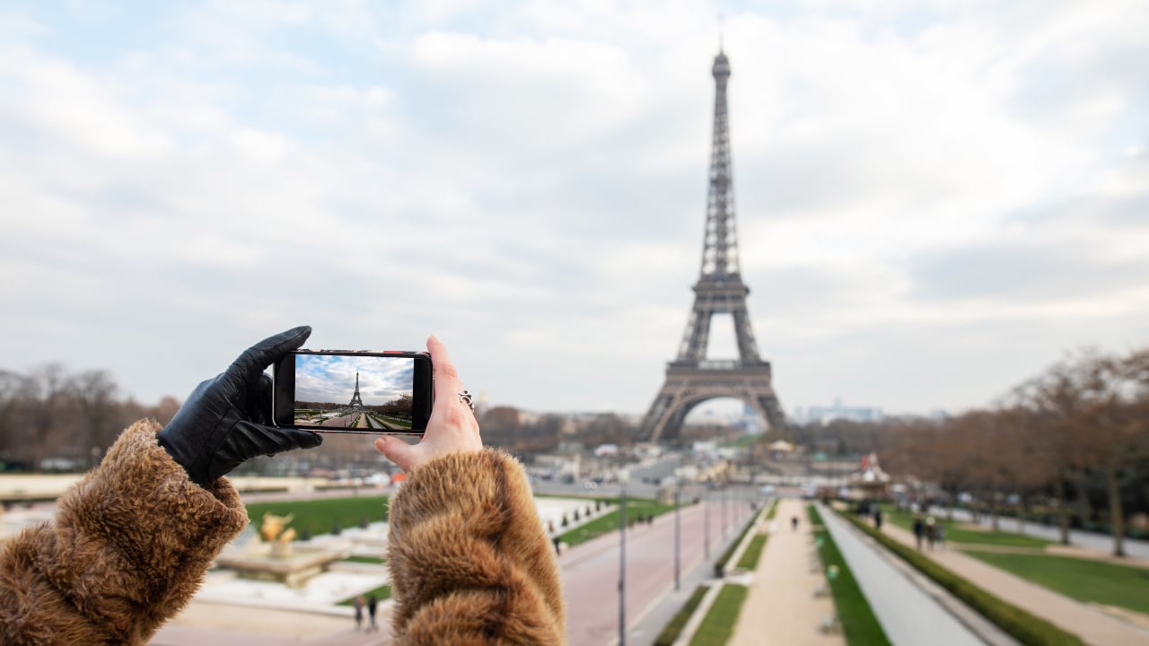 Tourist taking photo of Eiffel tower in Paris