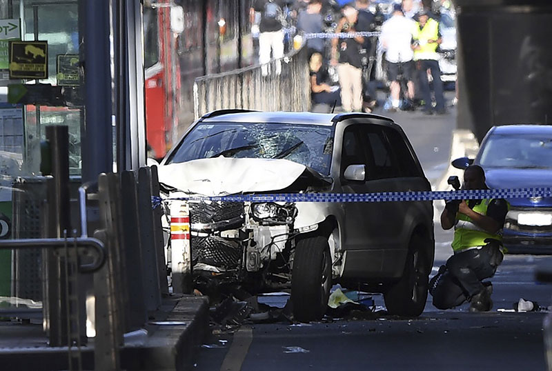 A damaged vehicle is seen at the scene of an incident on Flinders Street in Melbourne