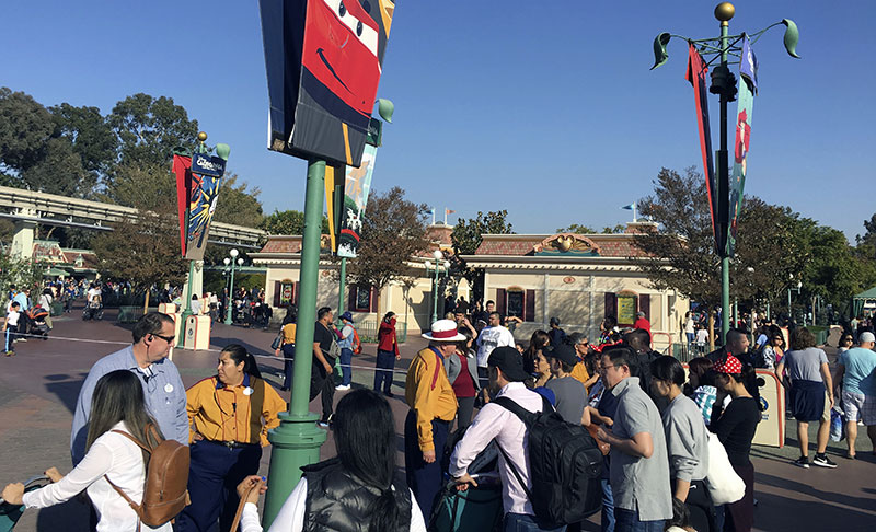 Disneyland park workers stop people from approaching the entrance as the turnstiles are roped off at the entrance of the park
