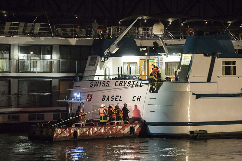 Rescuers arrive at the Swiss Crystal in Duisburg Germany after it struck a highway bridge on the Rhine river 