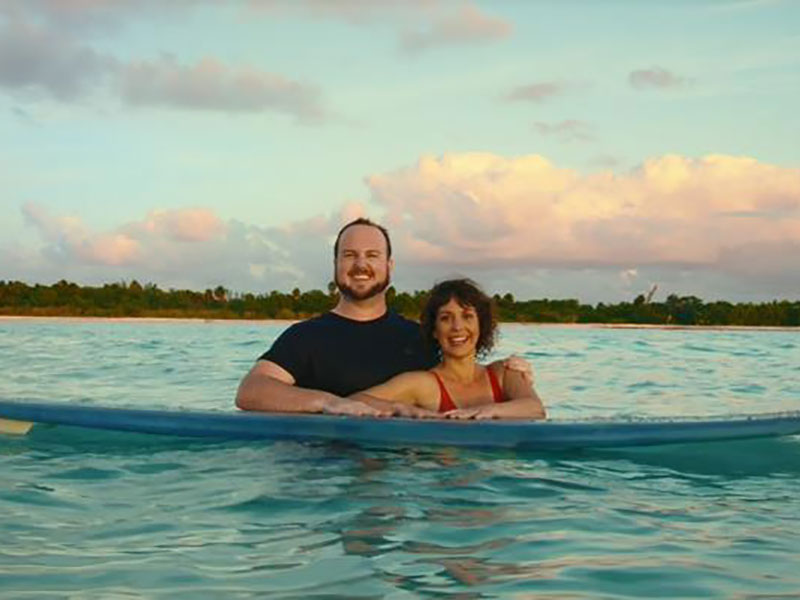 Couple floating on a stand-up paddleboard