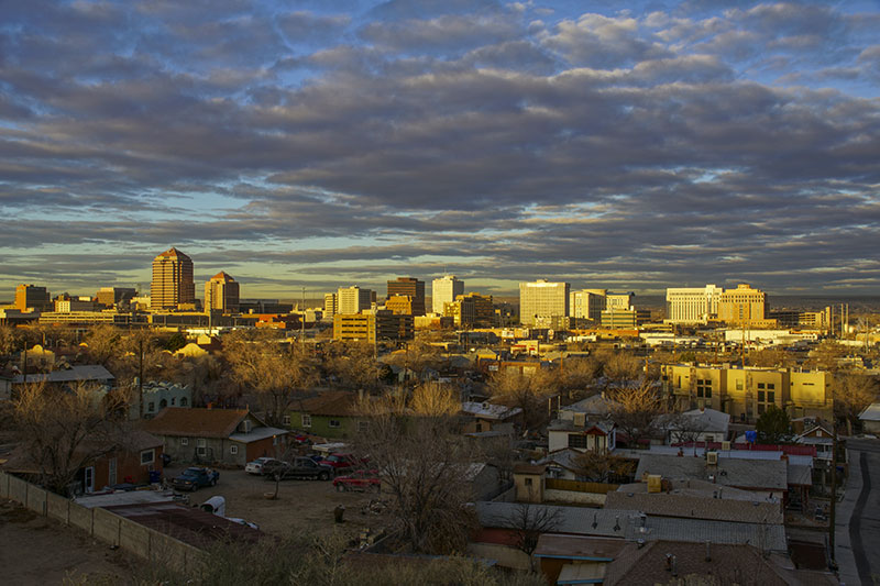 The downtown city skyline of Albuquerque New Mexico early in the morning as the sun illuminates the buildings with a golden 