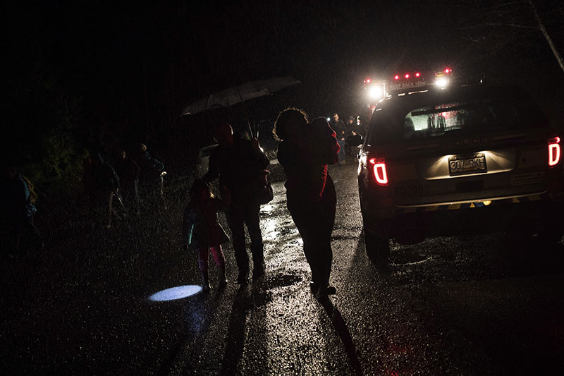 Tofino residents and visitors leave the community center after the tsunami warning ends in Tofino British Columbia