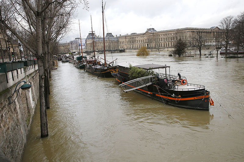 Boats are lined up along the flooded river Seine in Paris France