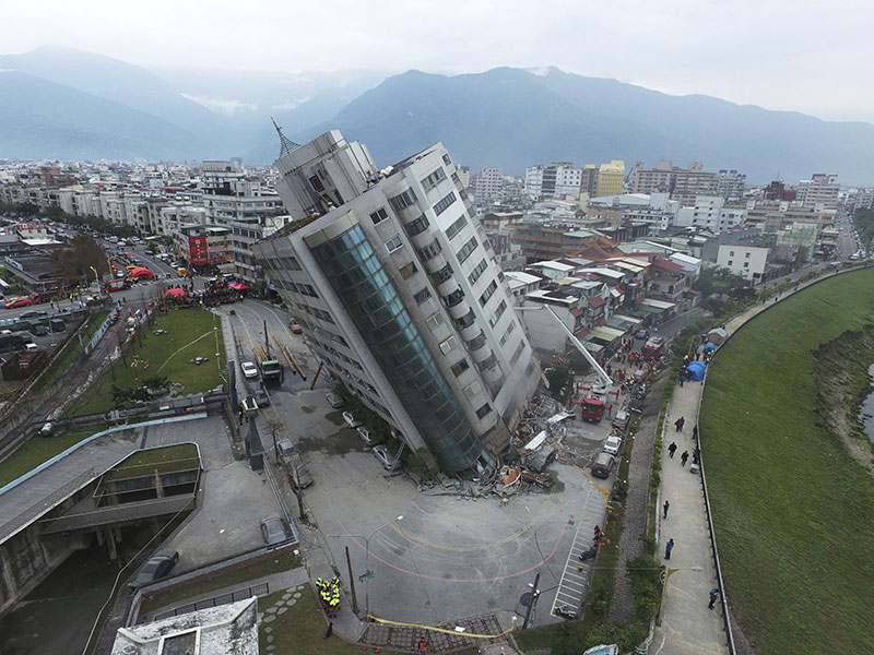 A residential building leans on a collapsed first floor following an earthquake in Hualien southern Taiwan