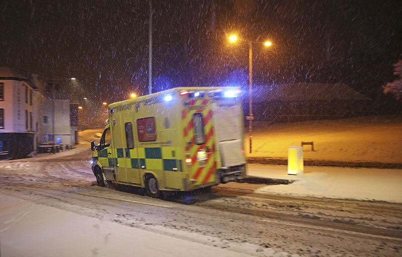 An ambulance drives through the snow in Tunbridge Wells southern England following heavy overnight snowfall which has cause